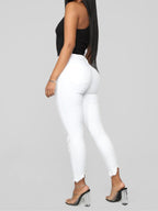 Women's elastic ripped solid color denim long trousers